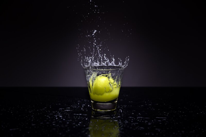 lemon splashing in glass