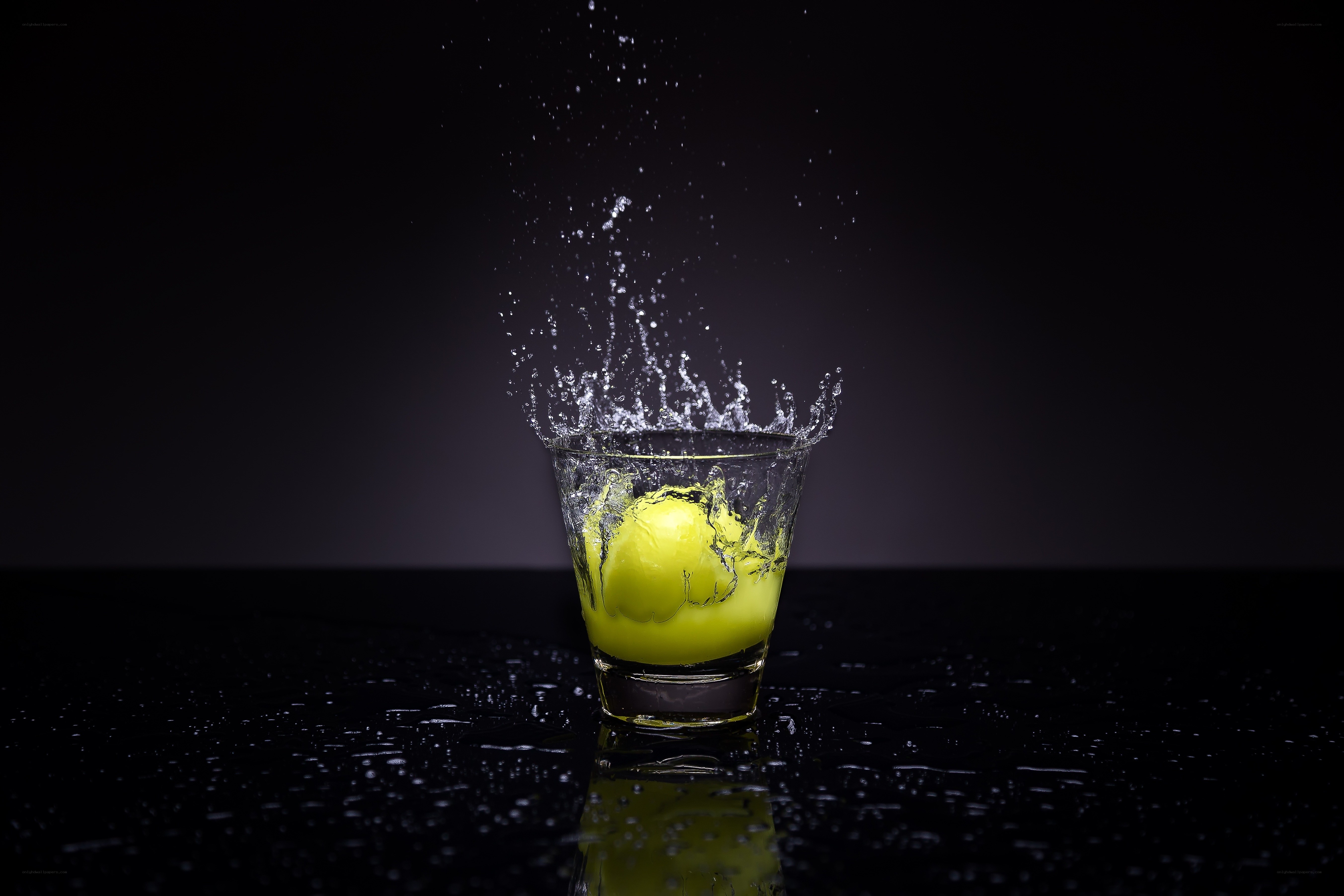 lemon splashing in glass