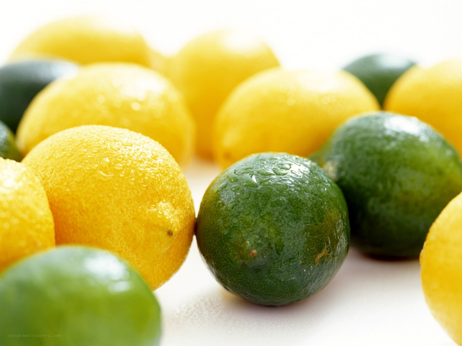 lemons and limes with water droplets