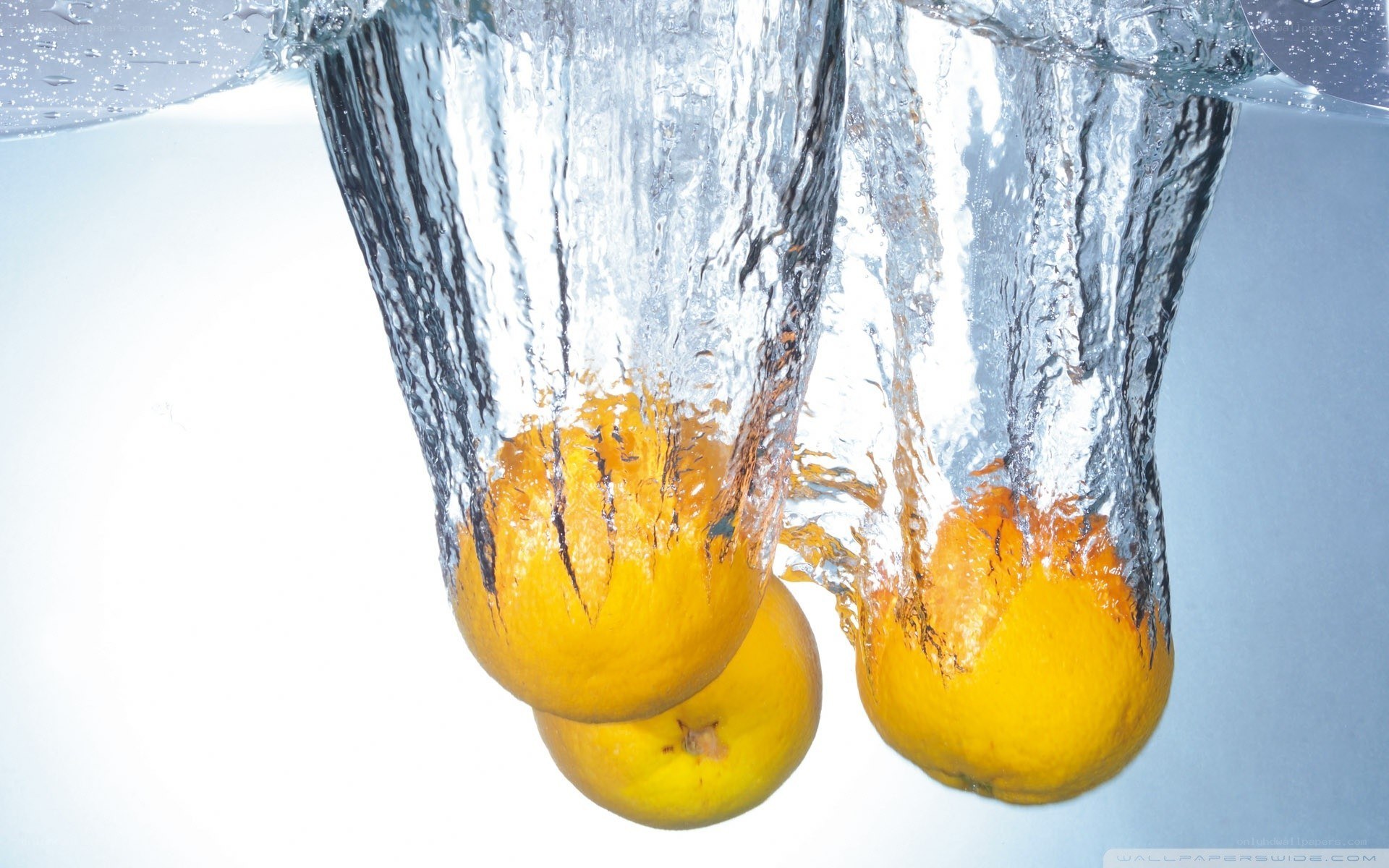 lemons falling into water