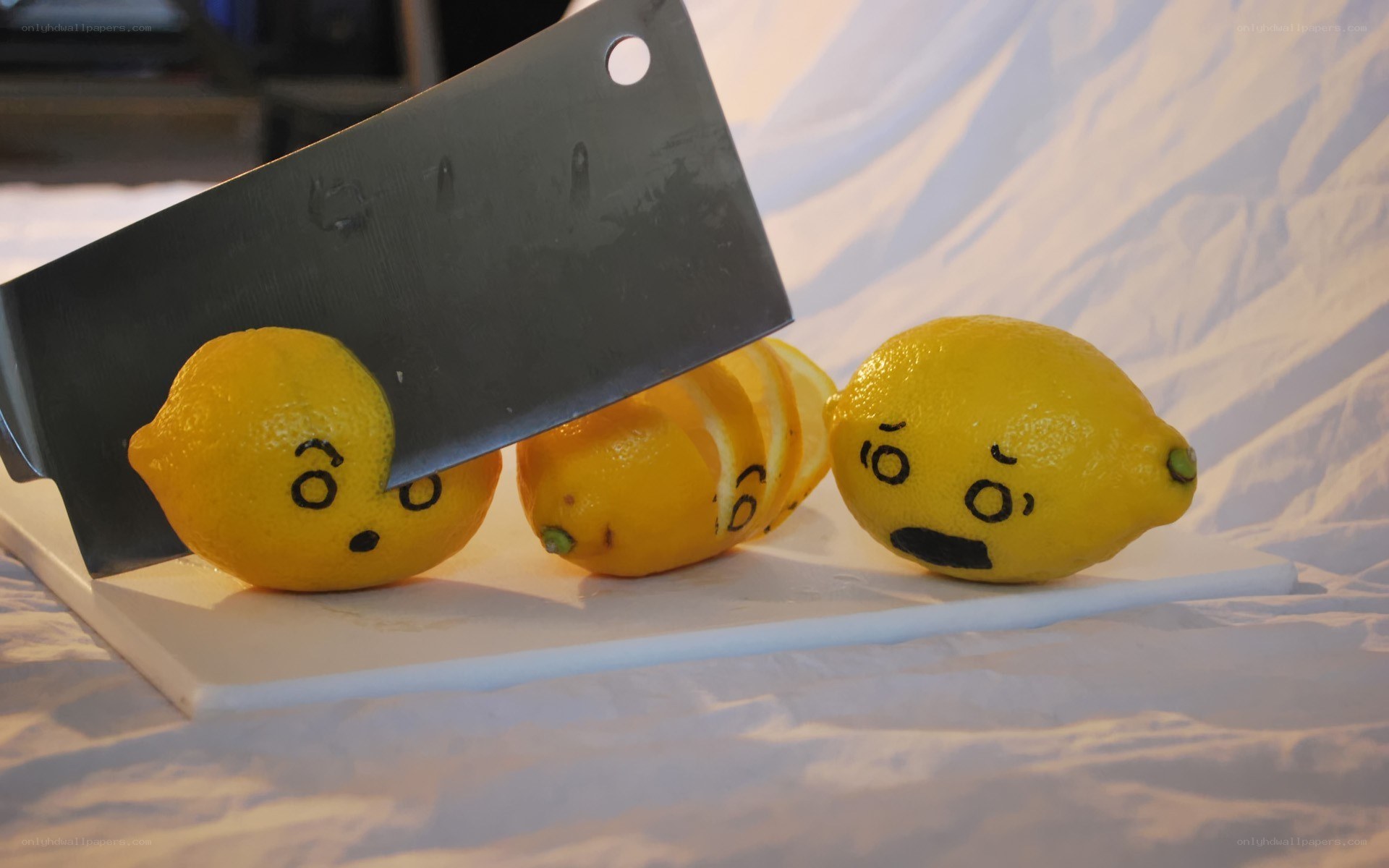 Lemons with knife on cutting board