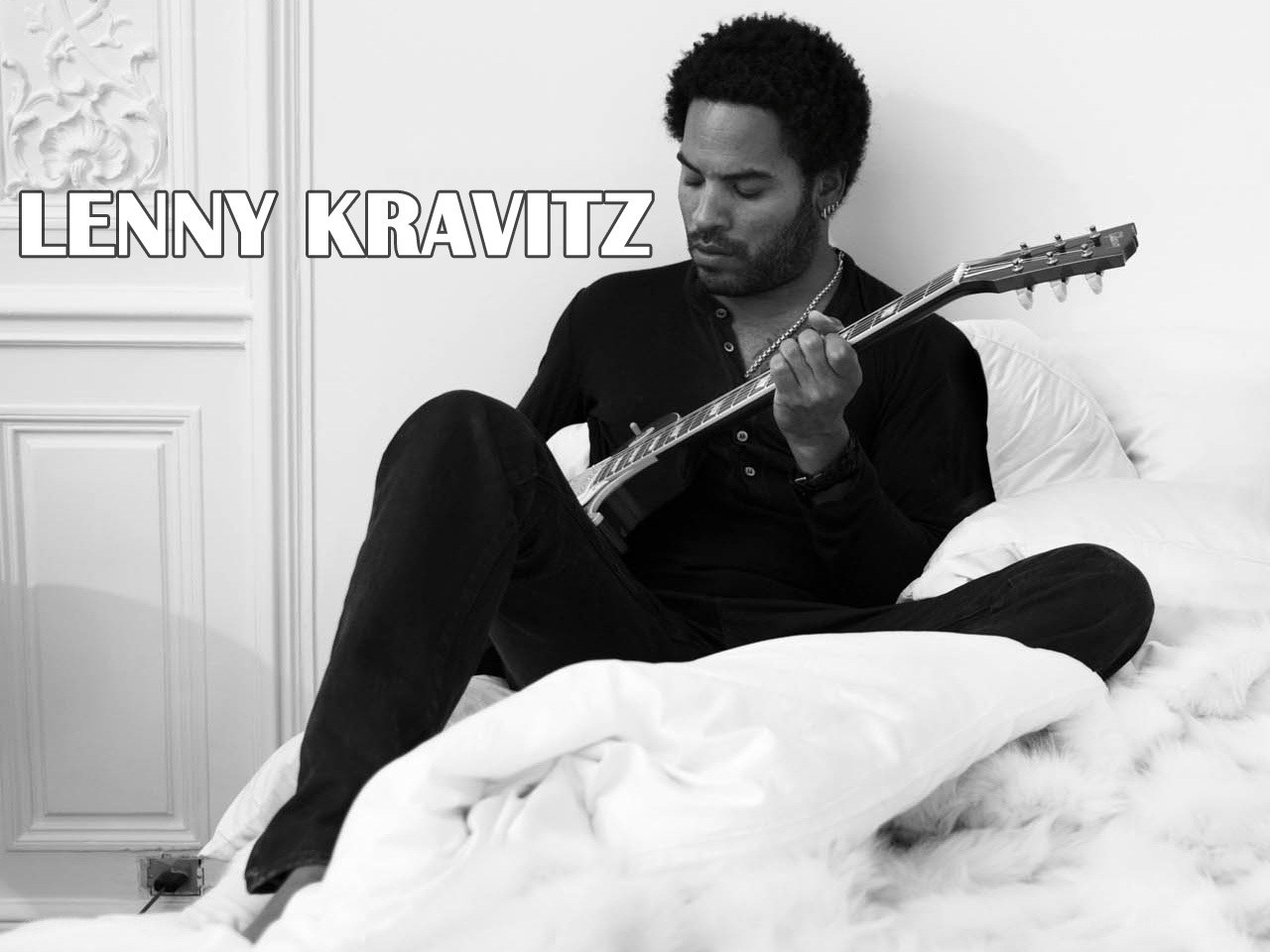 Lenny Kravitz playing guitar