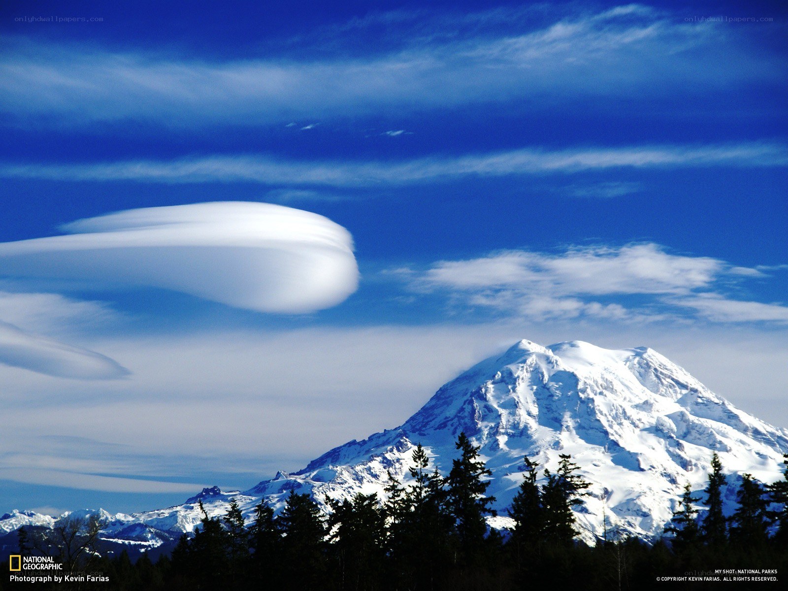 Lenticular cloud over a snow-capped mountain