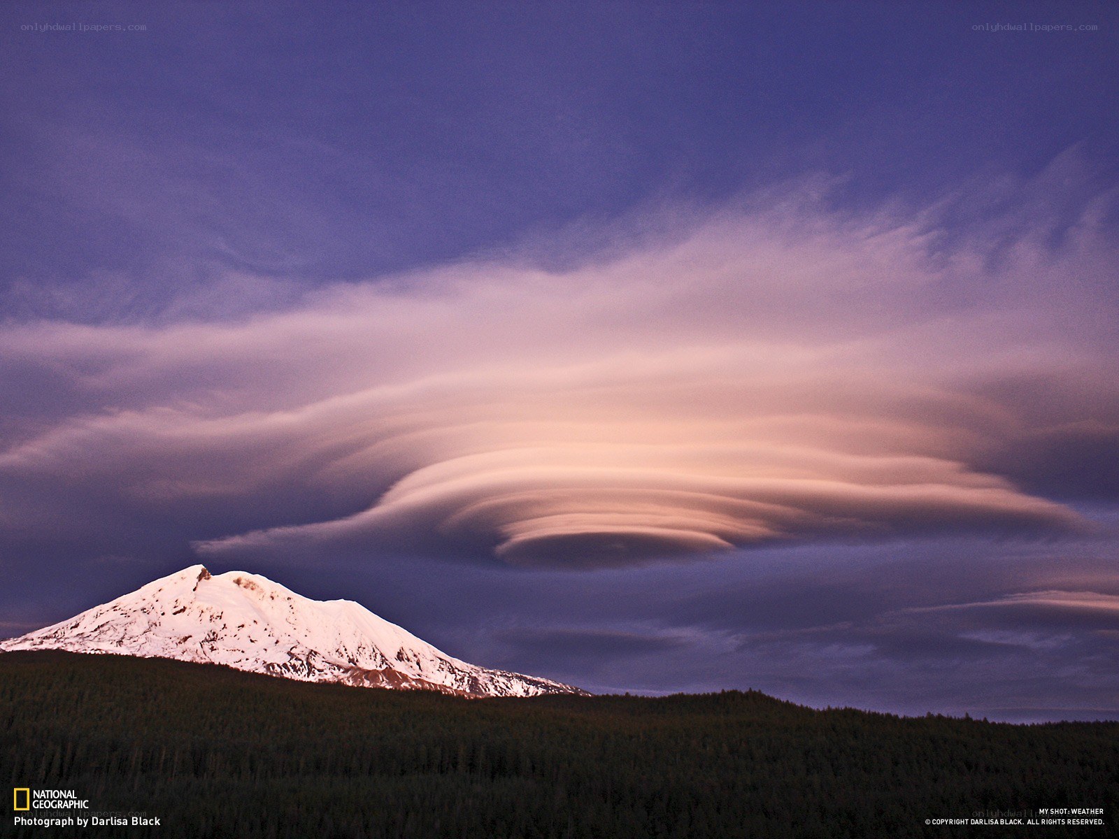 Lenticular cloud over snow-capped mountain