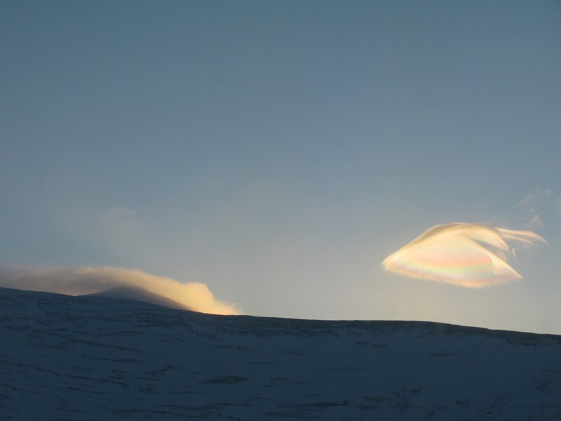 Lenticular cloud over snowy mountains
