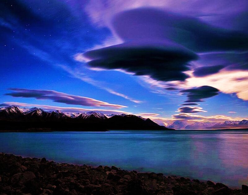 Lenticular clouds over a mountain lake