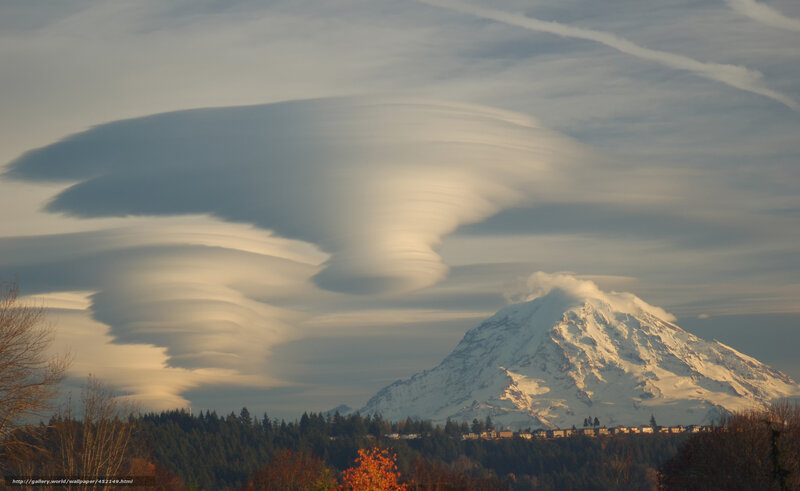Lenticular clouds over a snow-capped mountain