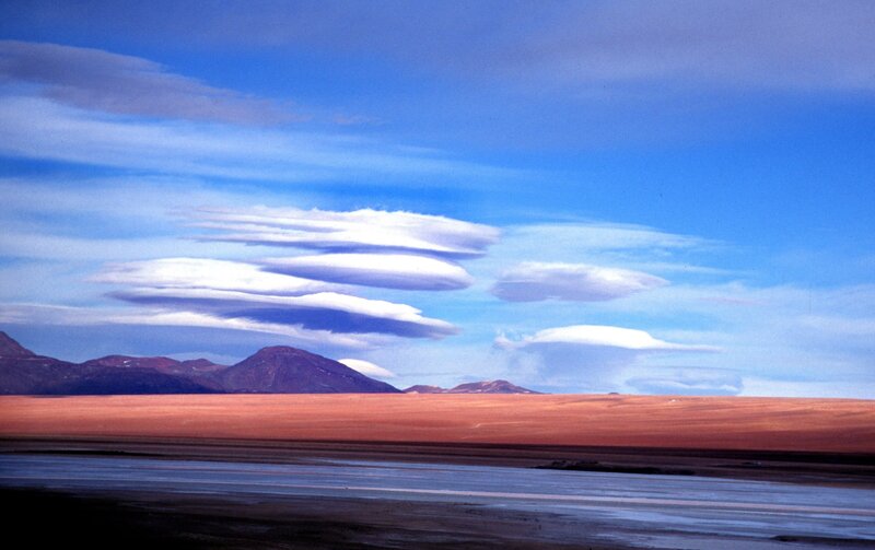 Lenticular clouds over desert landscape