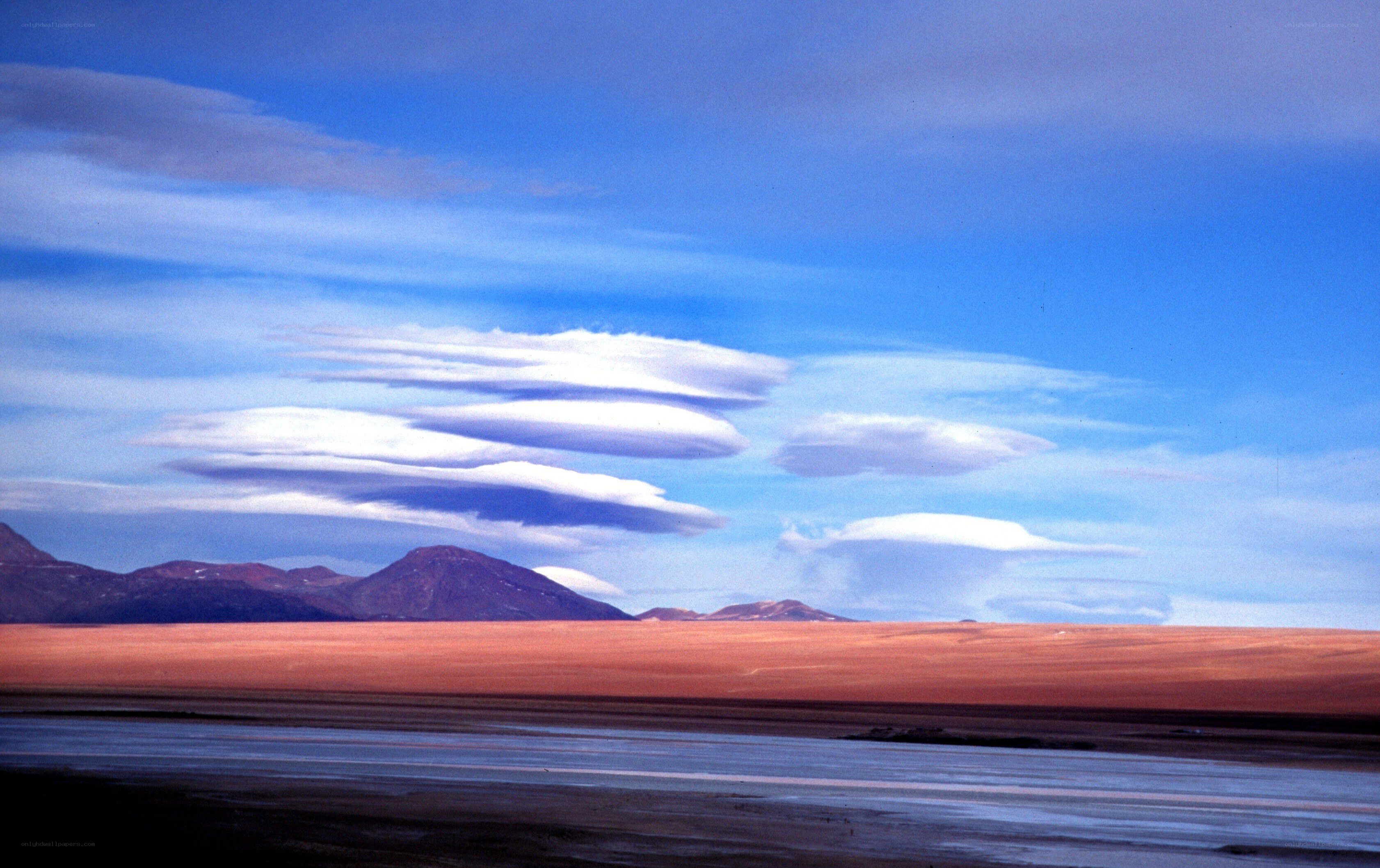 Lenticular clouds over desert landscape