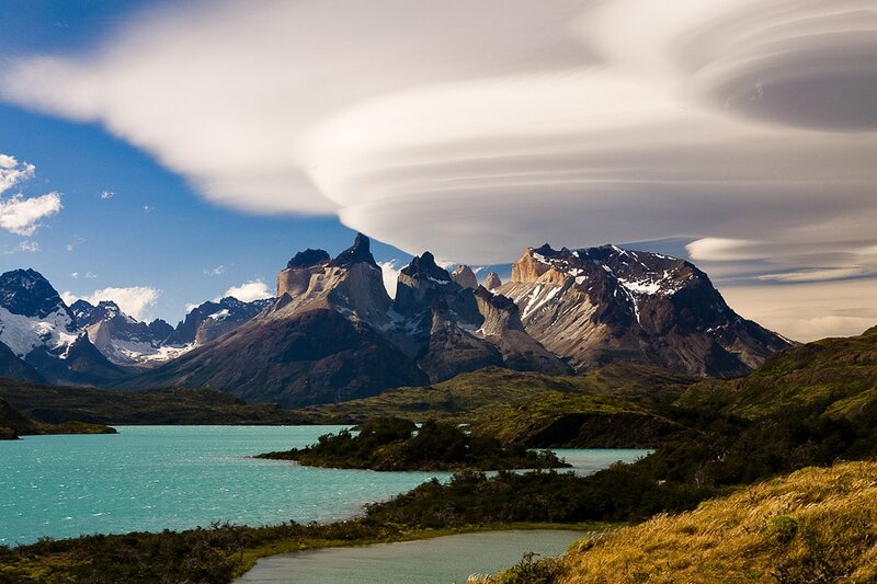 Lenticular clouds over mountain lake
