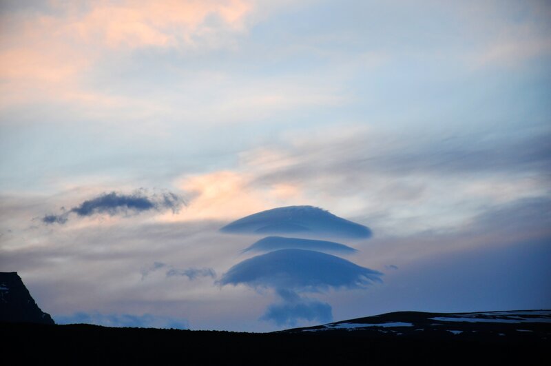 Lenticular clouds over mountains