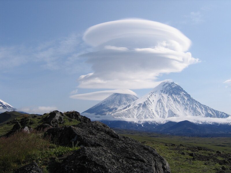 Lenticular clouds over snow-capped mountains