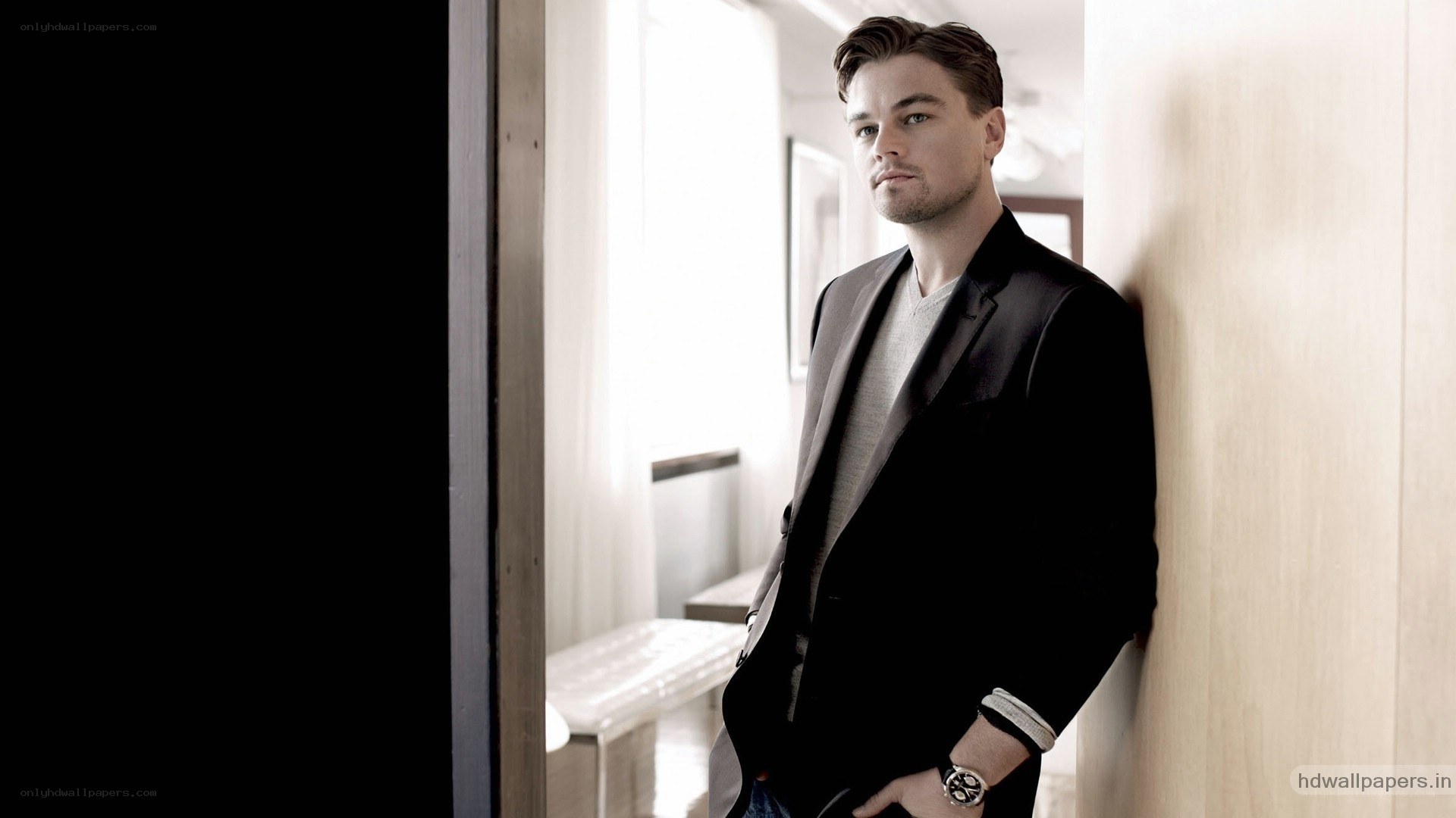Leonardo DiCaprio leaning against wall