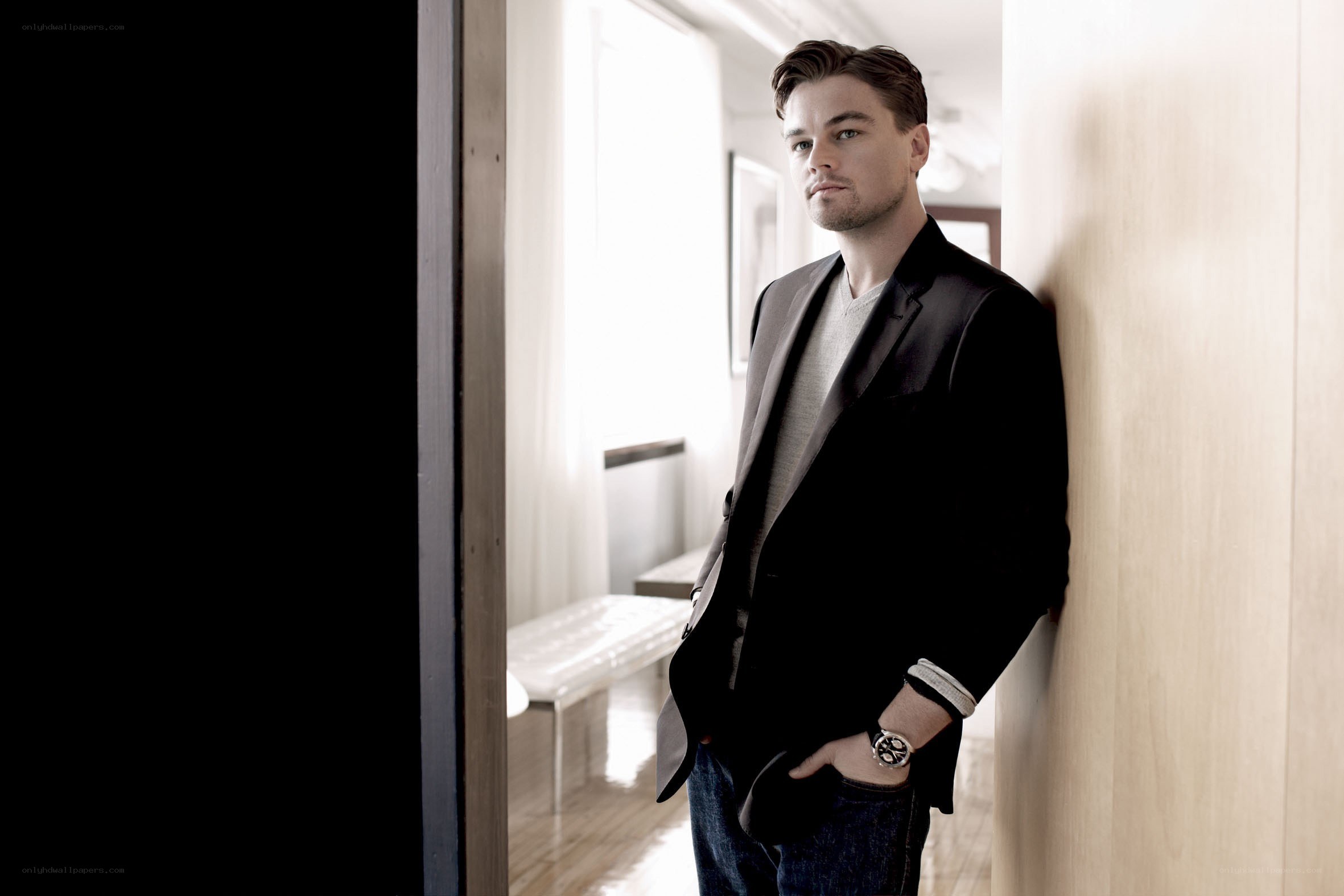 Leonardo DiCaprio leaning against wall