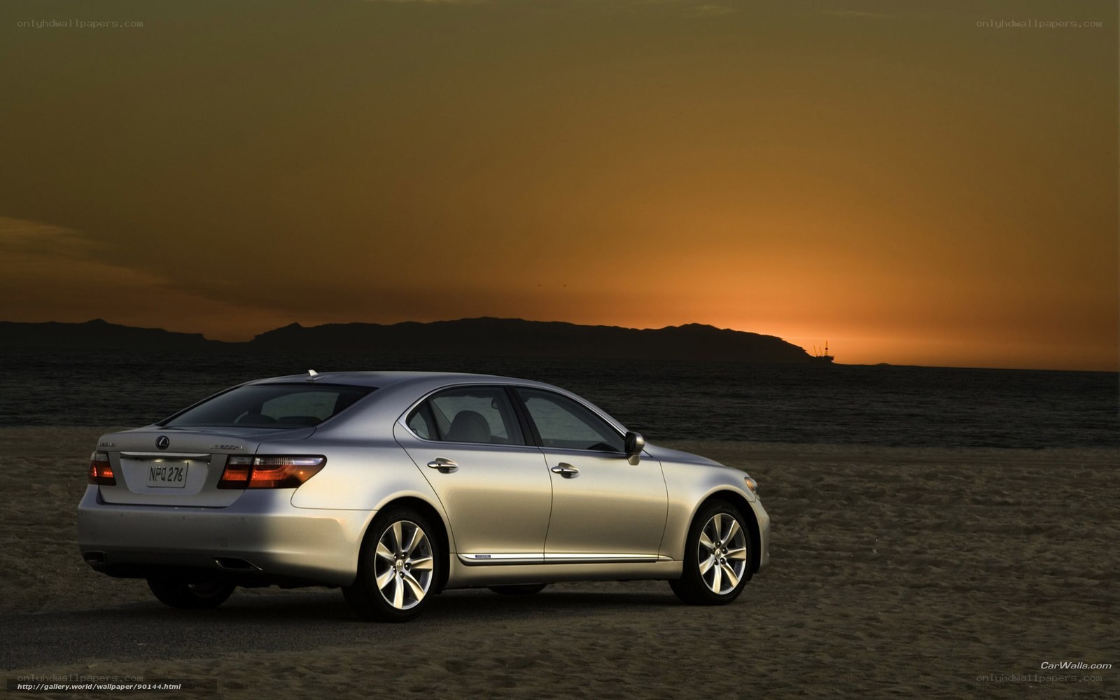 Lexus sedan on beach at sunset