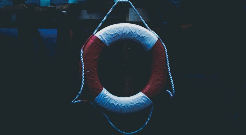 Life preserver hanging in dim light