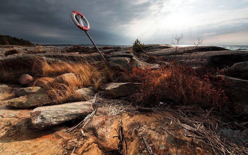Lifebuoy on rocky shore