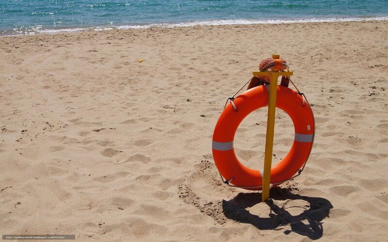 Lifebuoy on sandy beach