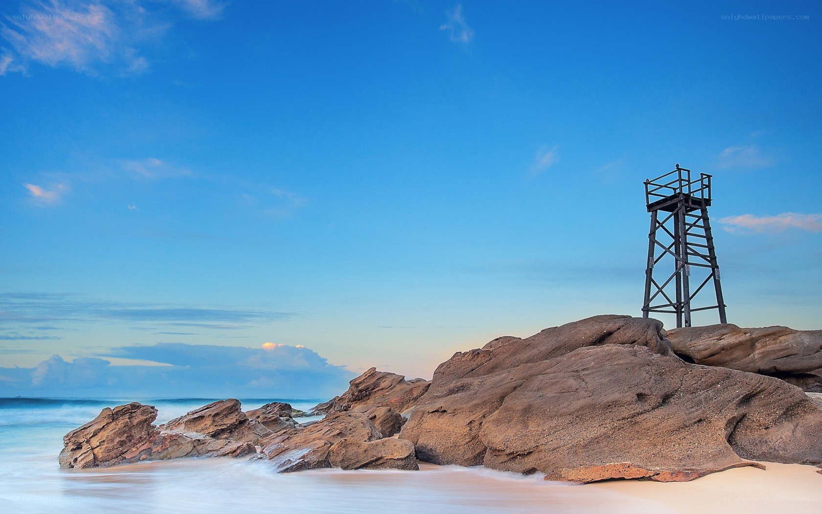 Lifeguard tower on rocky beach