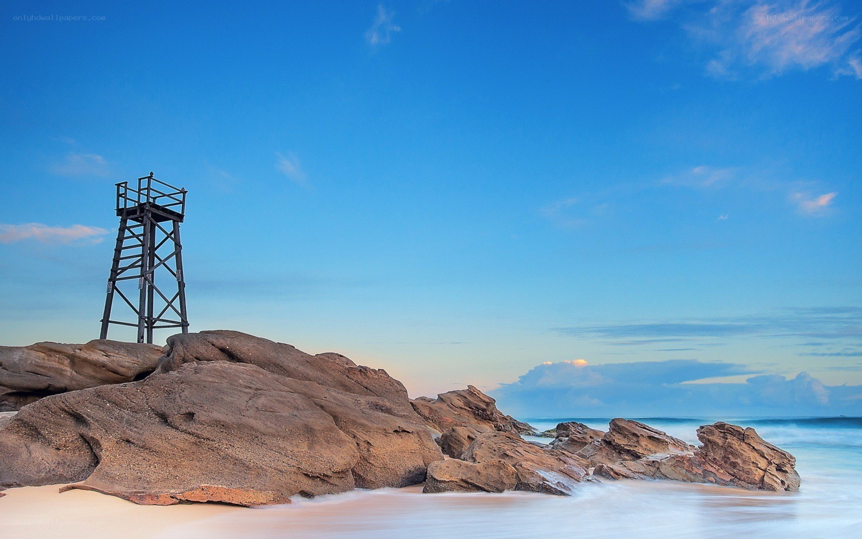 Lifeguard tower on rocky beach