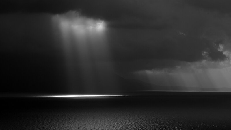 Light beams through storm clouds