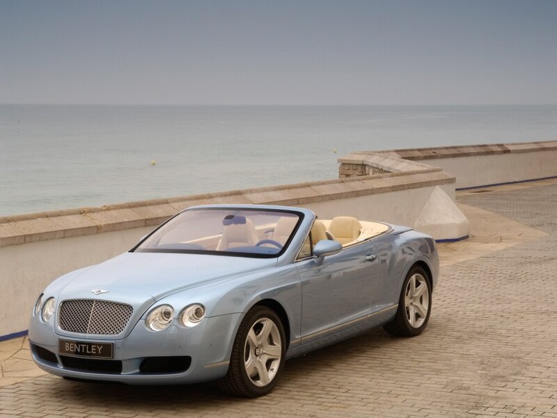 Light blue Bentley convertible by the sea