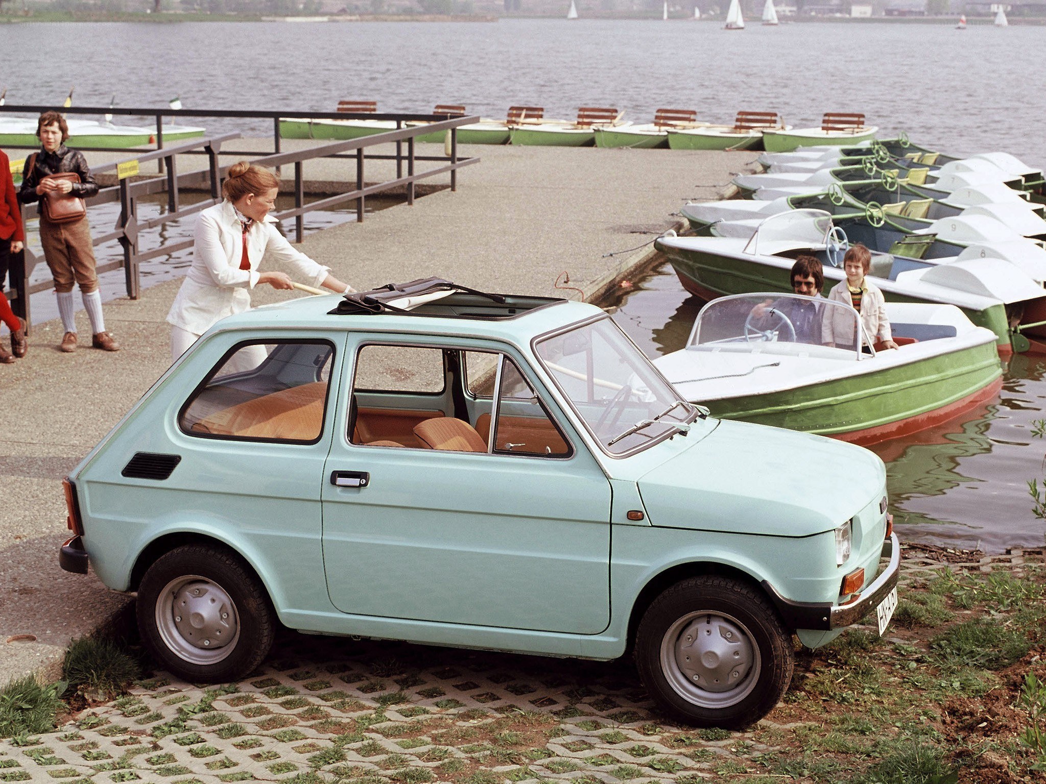 Light blue car by the lake
