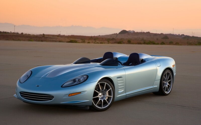 light blue sports car at sunset