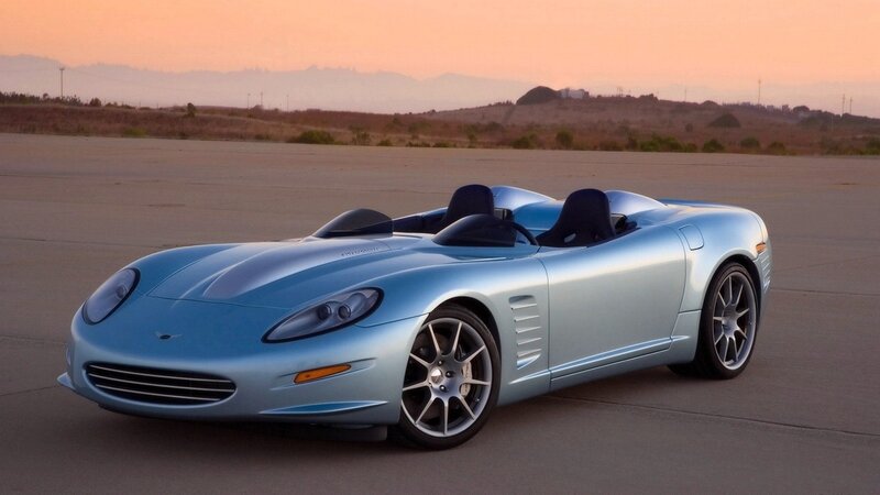 light blue sports car at sunset