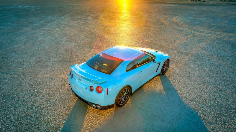 Light blue sports car at sunset