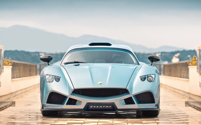 Light blue sports car on a bridge