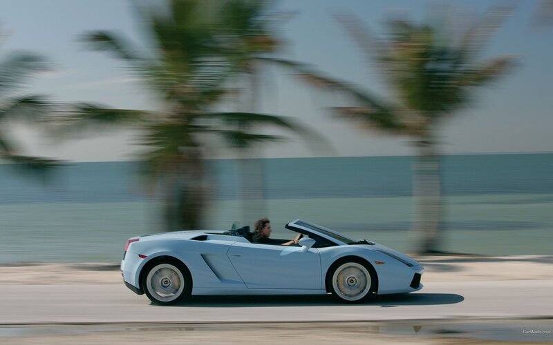 Light blue sports car on beach road