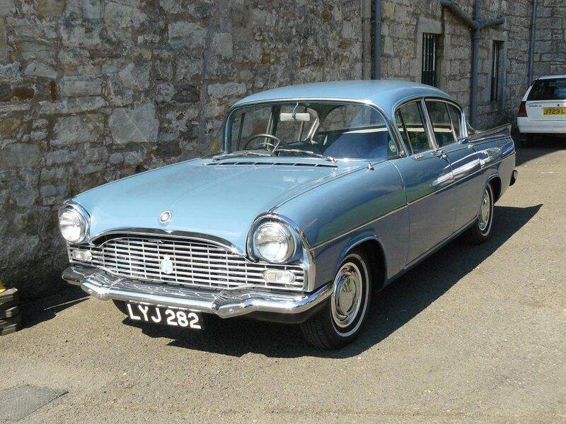 Light Blue Vintage Car — Calm, Afternoon, Photograph, Stone Wall