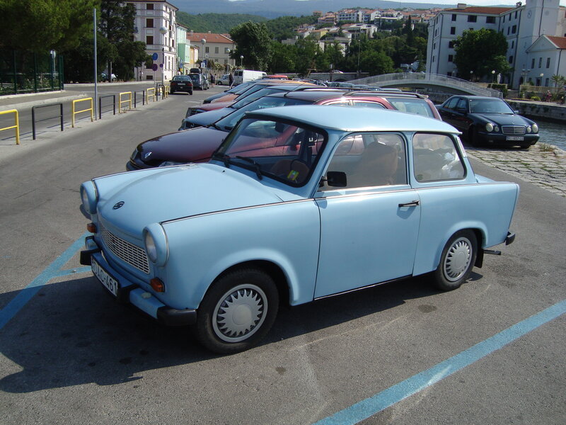 Light blue vintage car in parking lot