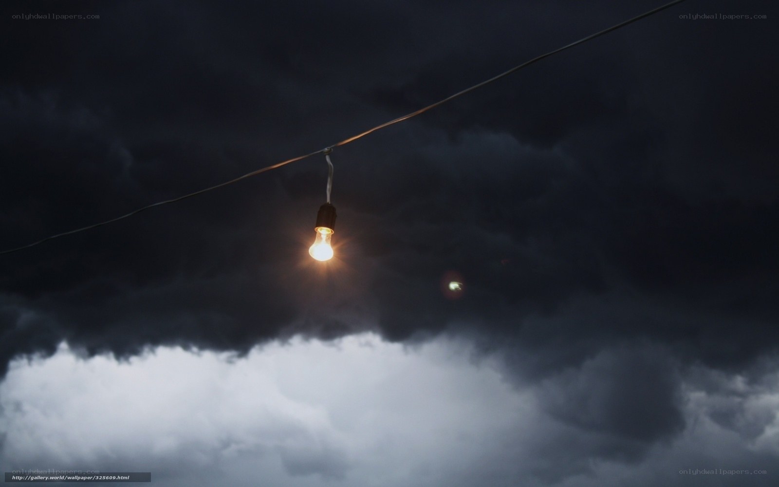 Light bulb in stormy sky