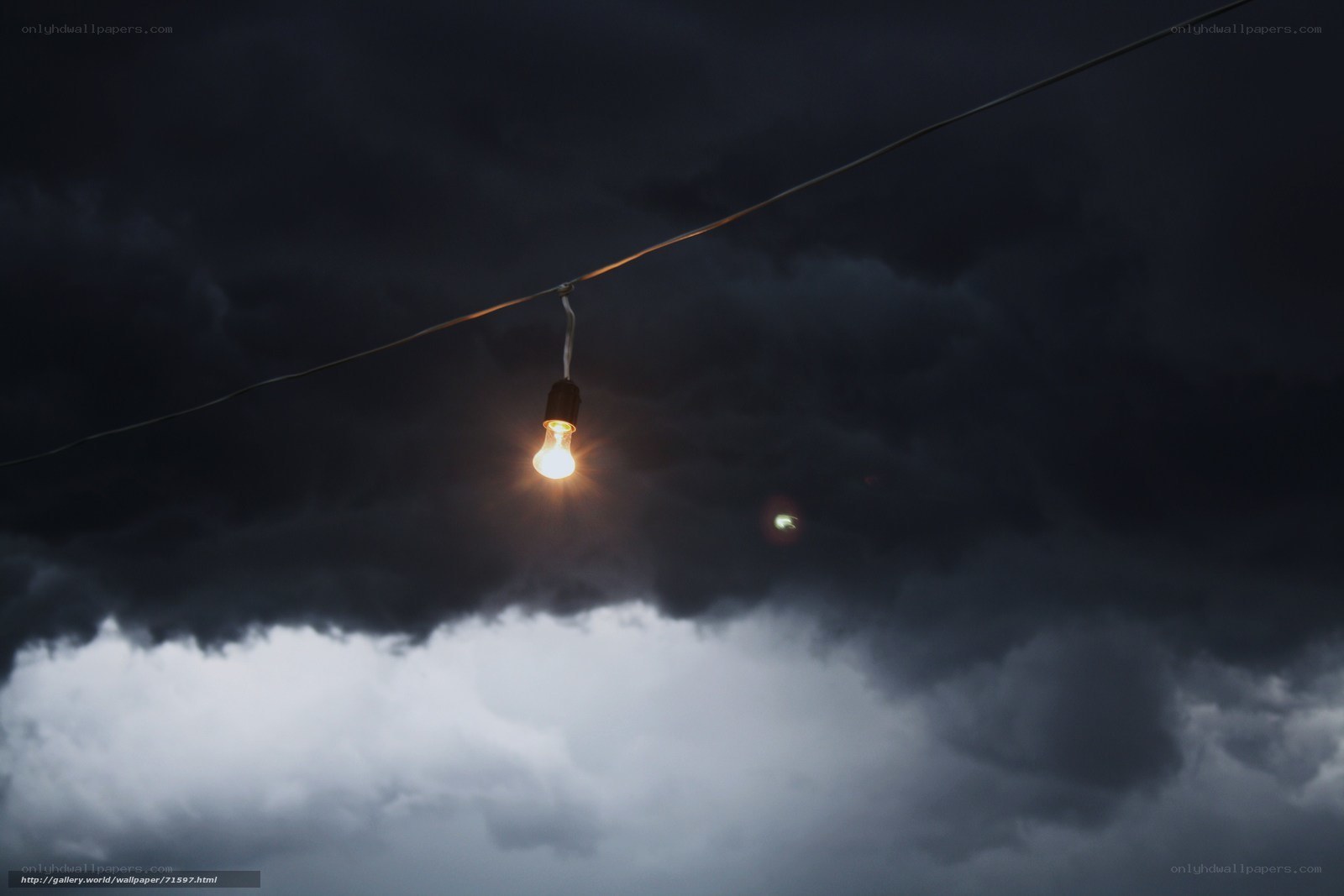 Light bulb in stormy sky