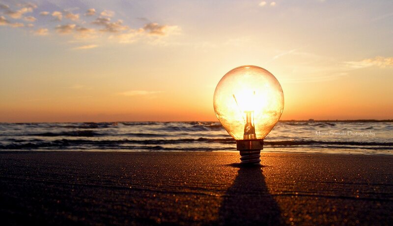 Light bulb on beach at sunset