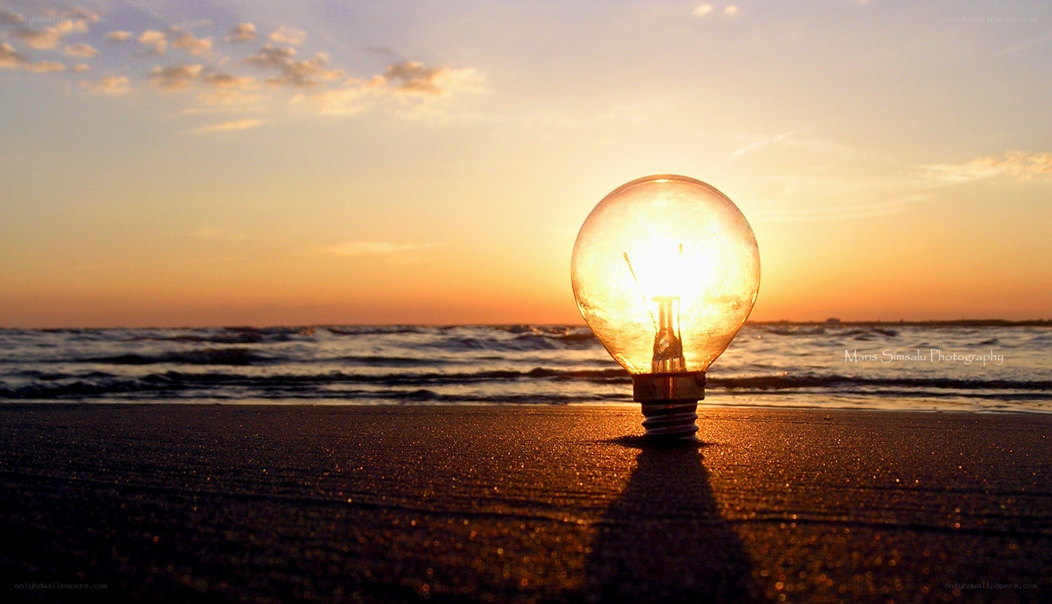 Light bulb on beach at sunset