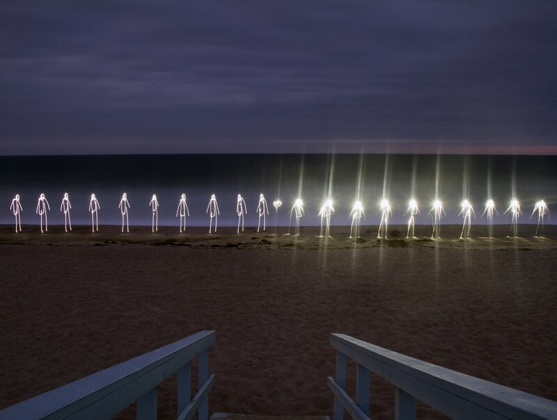 Light figures on a beach