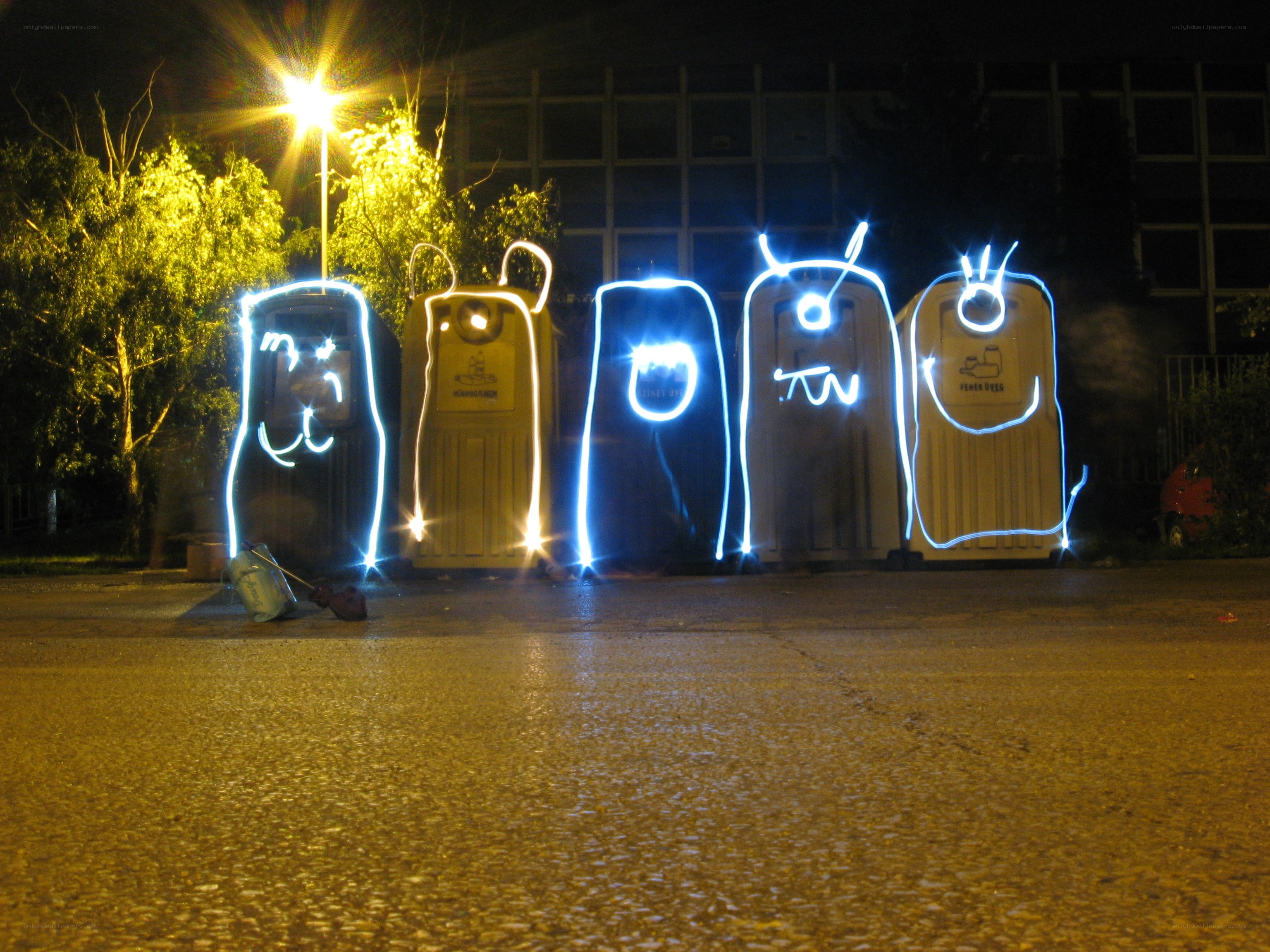 Light-painted portapotties at night