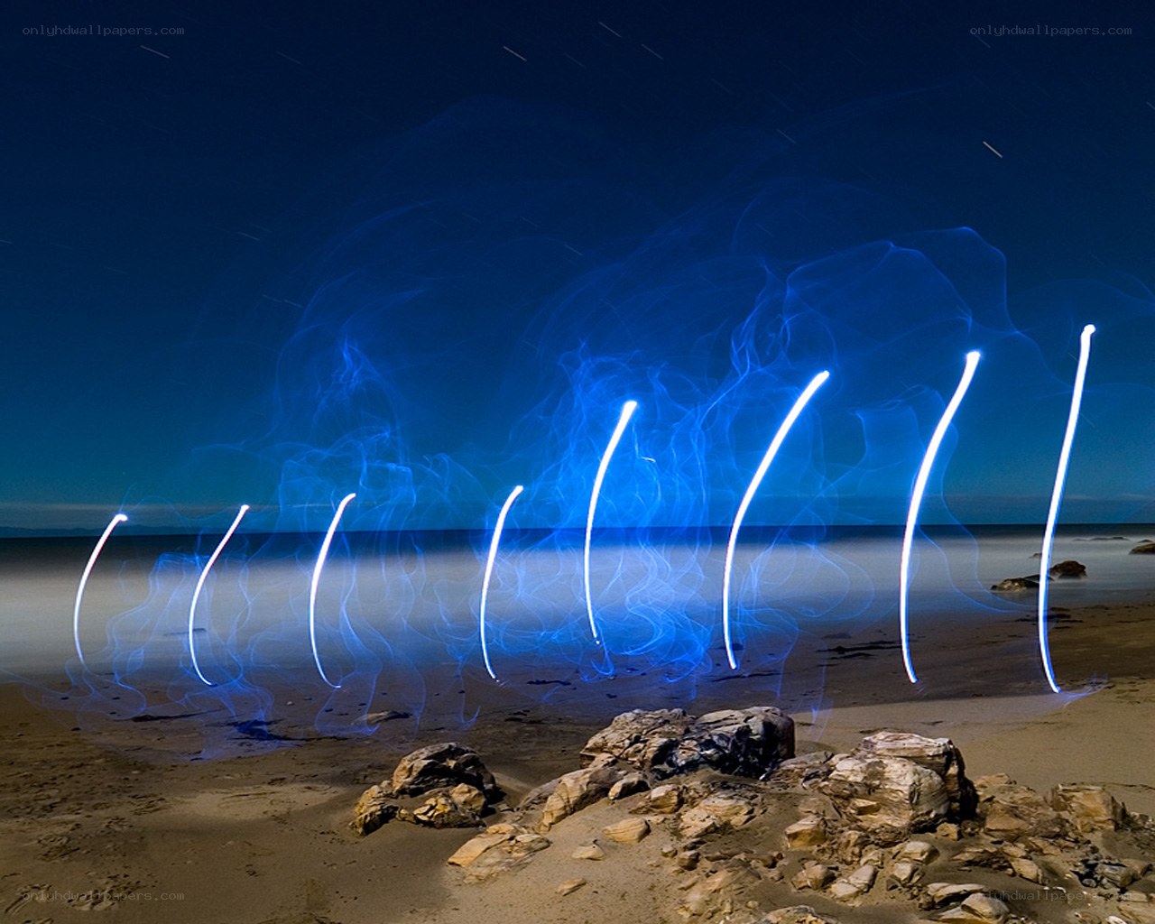 Light painting on a beach at night