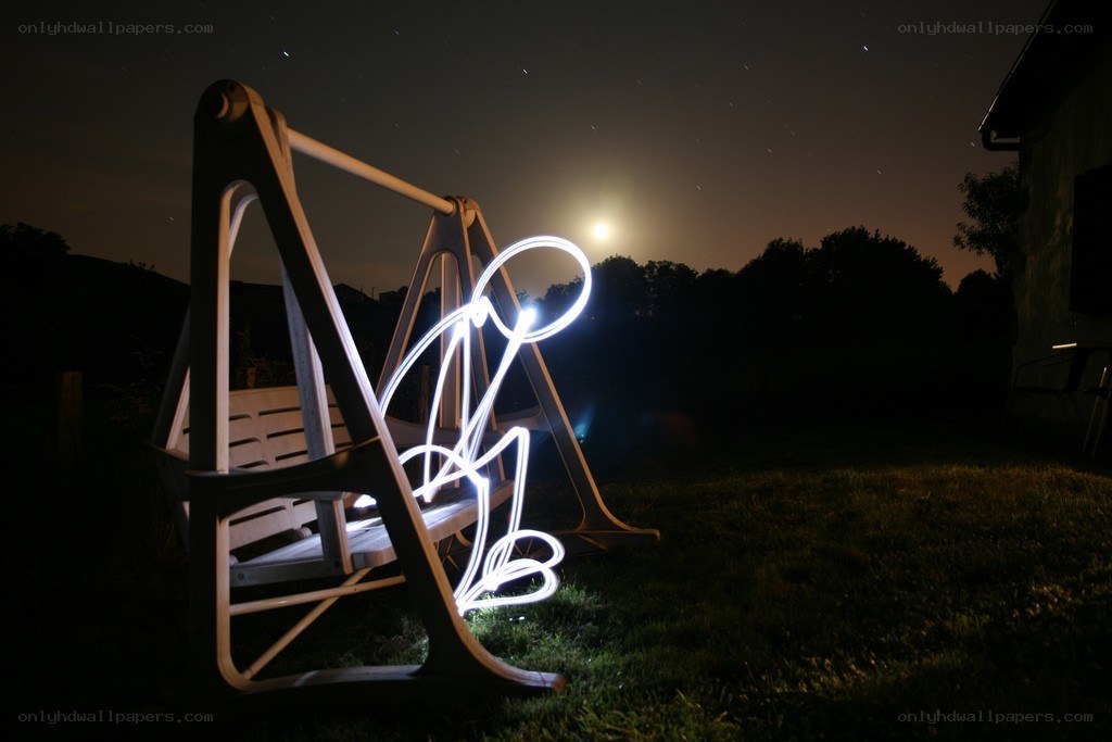 Light painting on a swing at night