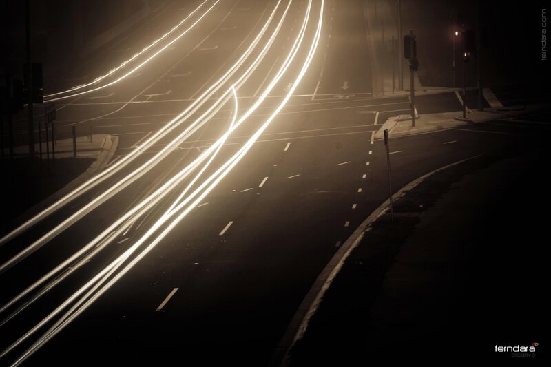 Light trails on a foggy road