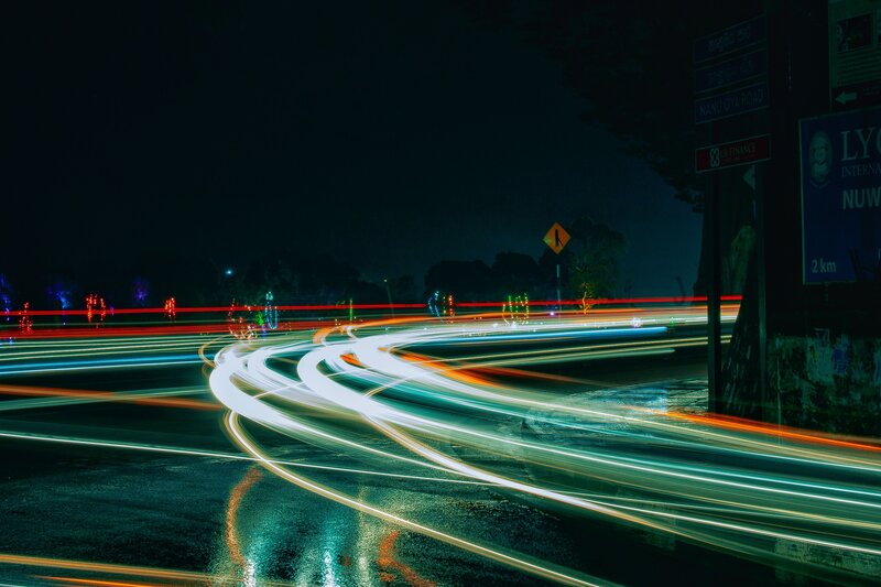Light trails on a wet road at night