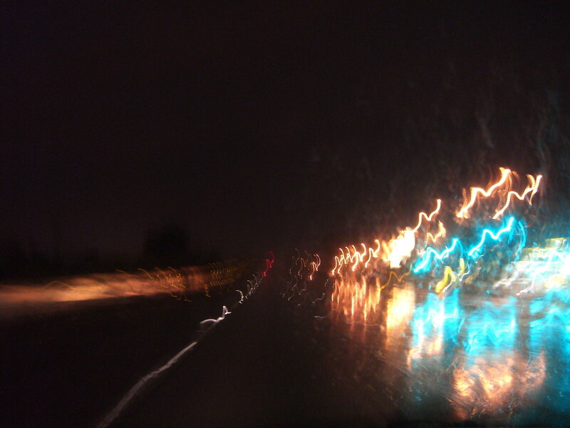 light trails on wet road at night