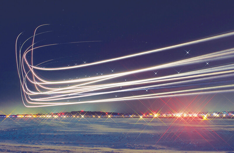 Light trails over snowy landscape