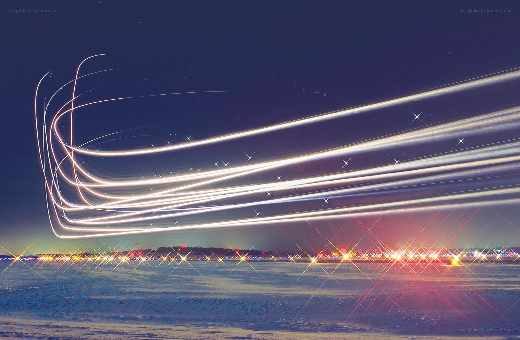Light trails over snowy landscape