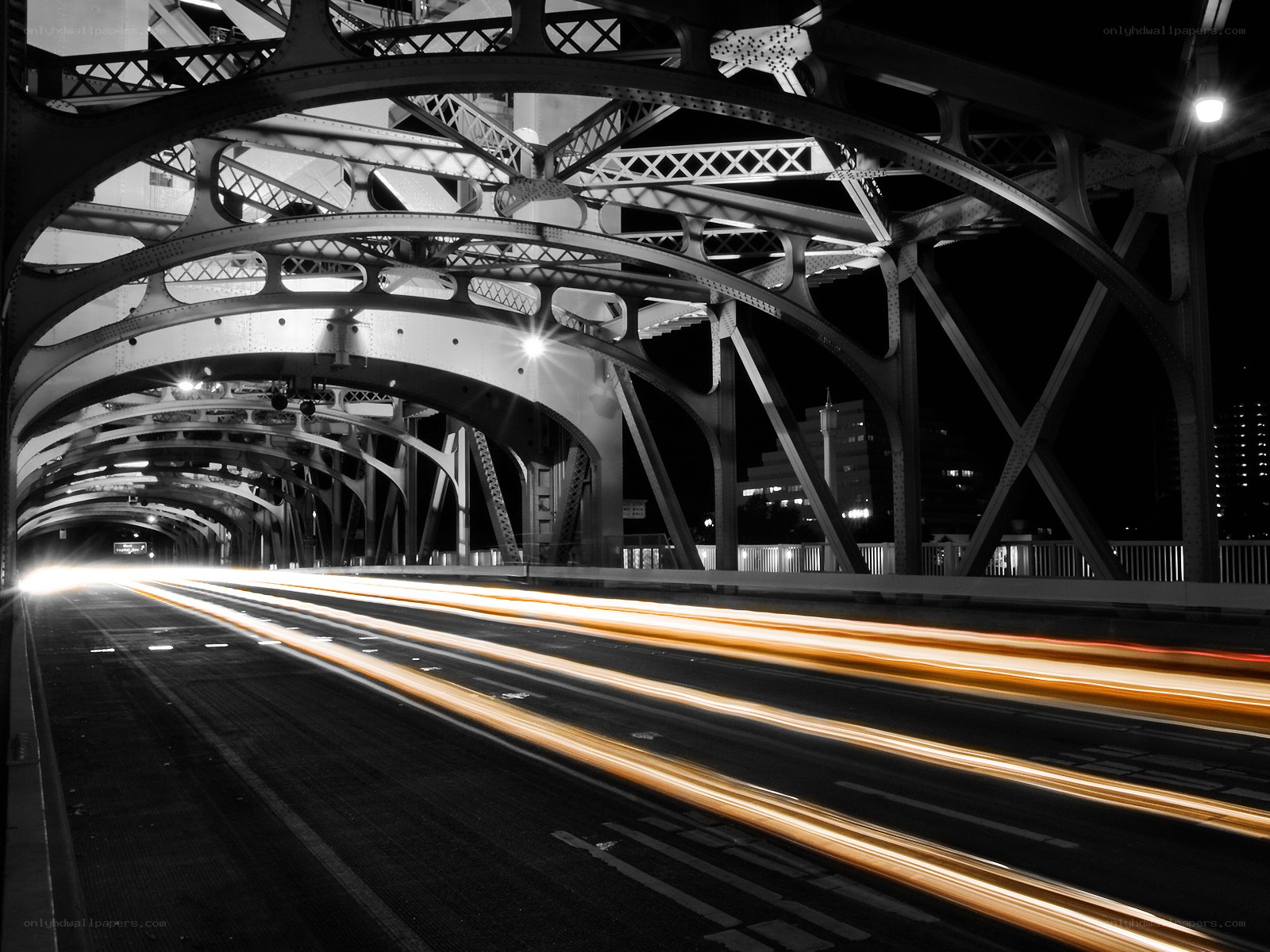 Light trails under a bridge at night