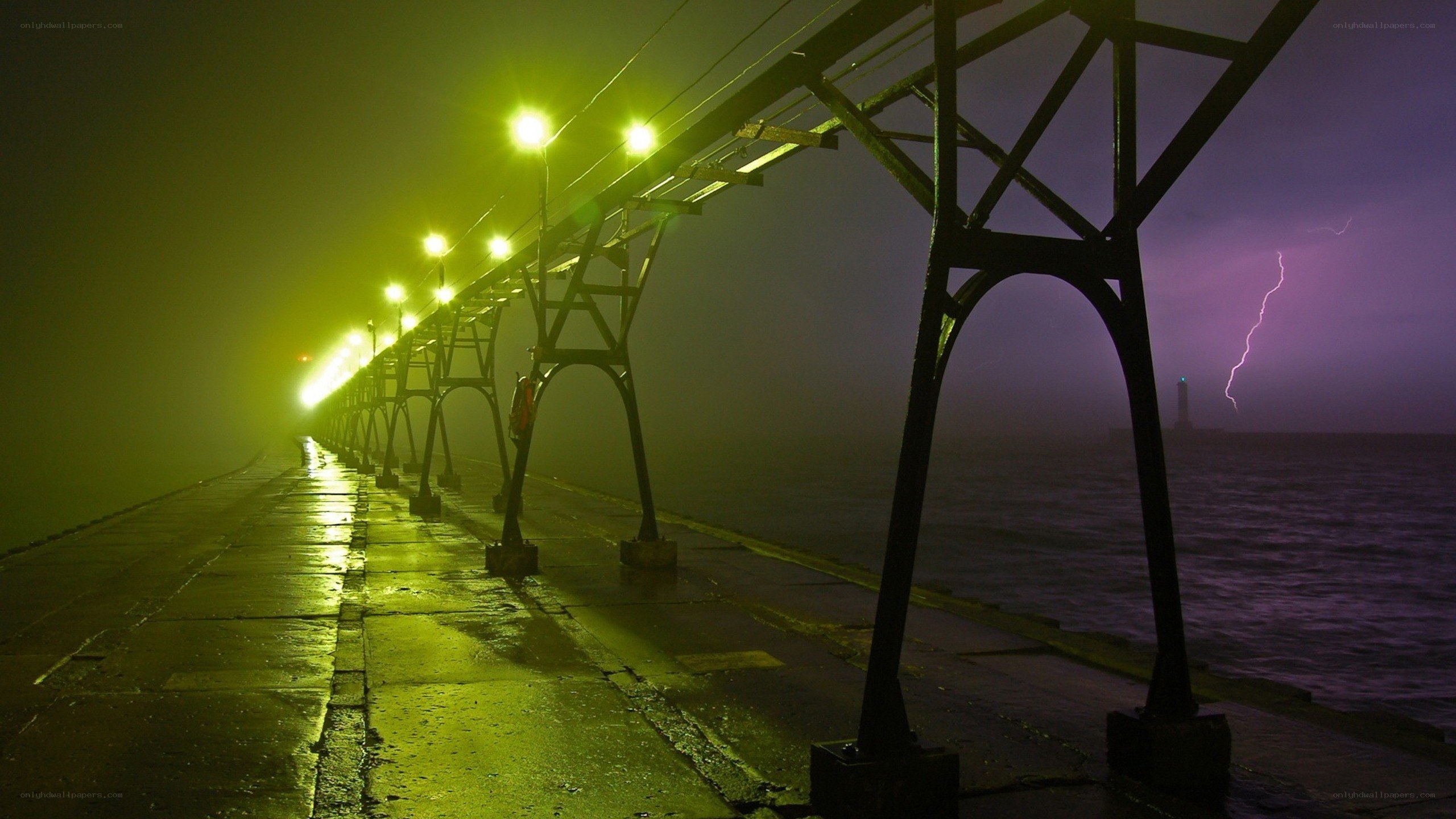Lighted pier during storm