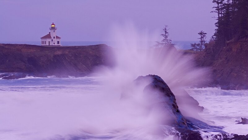 Lighthouse at coastal cliff